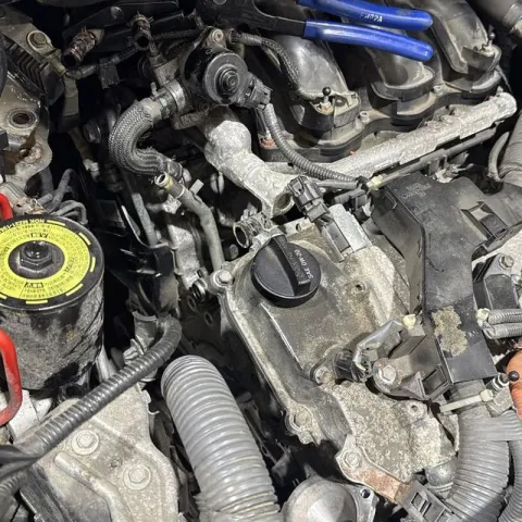 An engine bay opened up for repair on a Manko Mobile Automotive job